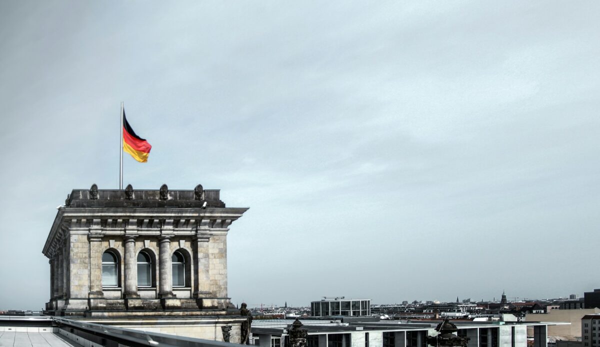 German flag on top of the Bundestag building in Berlin as Germany’s 2027 budget increases defense spending and public borrowing.
