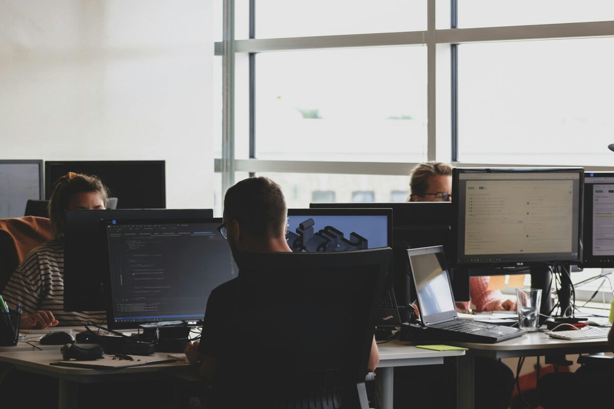 Office workers using computers as UK businesses face growing cybersecurity risks.