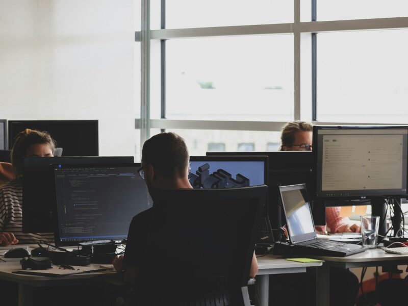 Office workers using computers as UK businesses face growing cybersecurity risks.