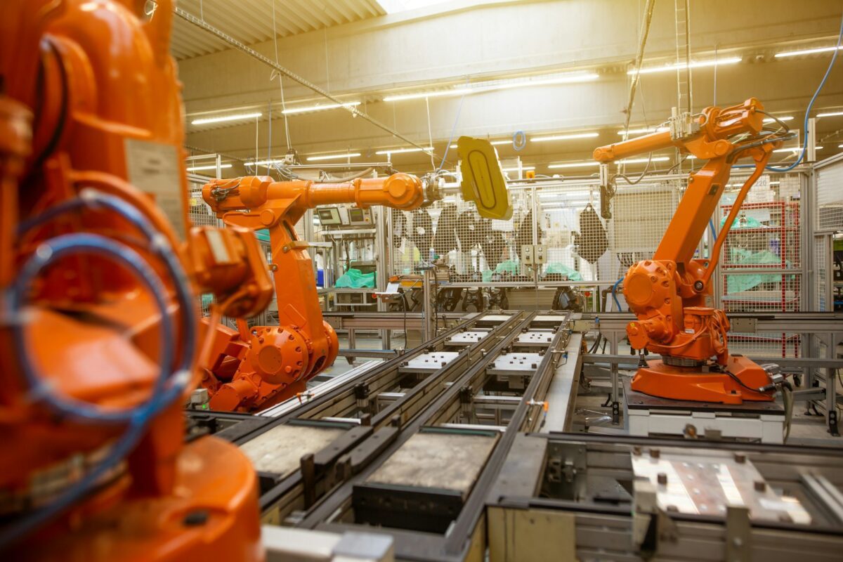 Robotic arms operating on a modern factory production line.