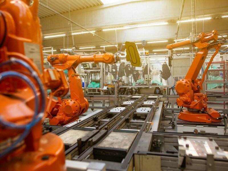 Robotic arms operating on a modern factory production line.